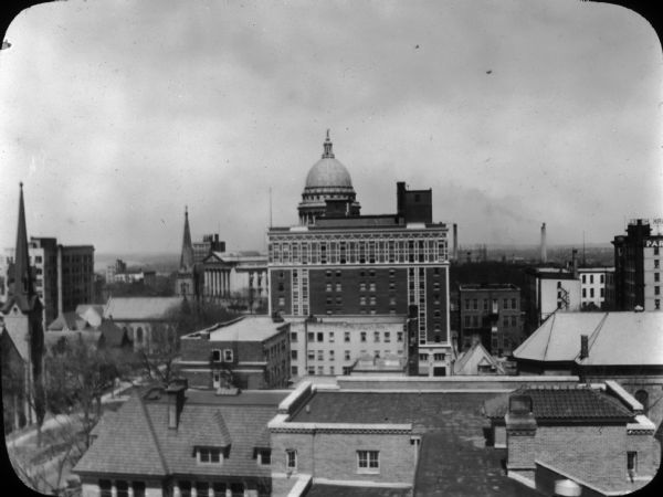 Madison skyline, looking from the roof of the recently-constructed Methodist Hospital toward the Wisconsin State Capitol, obscured by The Loraine Hotel, which was one of the most prominent gathering places in town.
