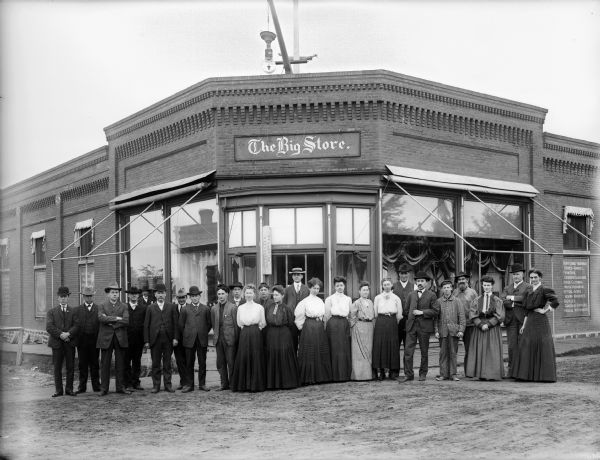 Group of salespeople standing in front of The Big Store.