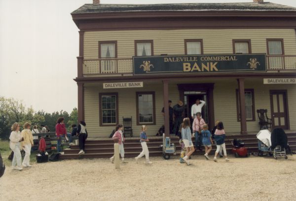 Tourists visit the historic Seven-Mile Inn at Old World Wisconsin transformed for its role as the Daleyville Bank in the ABC made-for-TV movie "Dillinger".