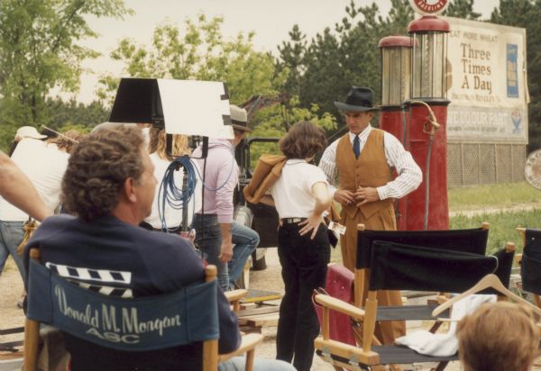 Actor Mark Harmon on the set at Old World Wisconsin. Harmon starred in the lead role in the made-for-TV movie "Dillinger". Cinematographer Donald M. Morgan is seated with his back to the camera. Morgan, who has received six Emmys, received the 1992 ASC award for outstanding cinematography for his work on "Dillinger".