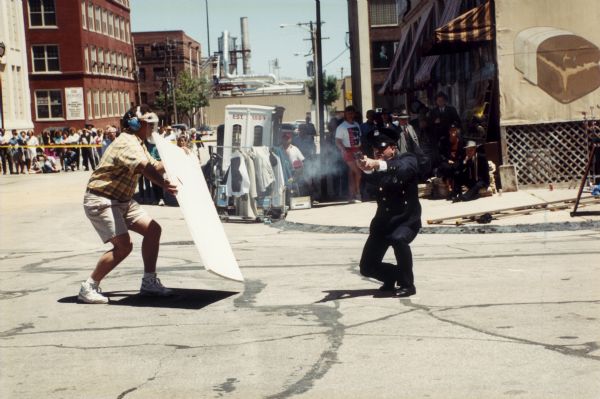 Scene from the made-for-TV movie "Dillinger" shot in part on the streets of Milwaukee. A crowd is watching in the background.