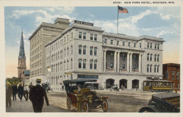 The Park Hotel, 22 South Carroll Street, on the Capitol Square with pedestrians, automobiles and a streetcar. Caption reads: "New Prk Hotel, Madison, Wis."