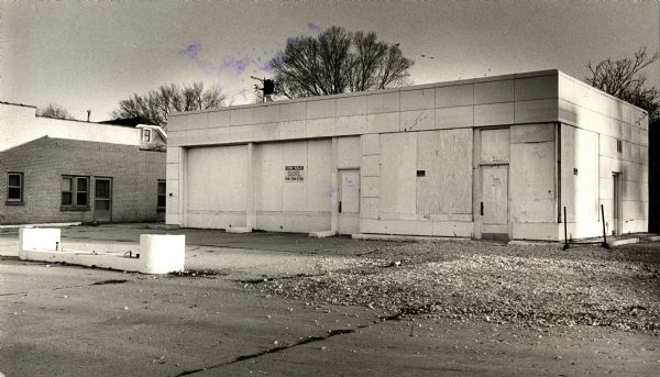 Exterior view of a boarded-up Amoco gas station at 6731 W. North Avenue.
