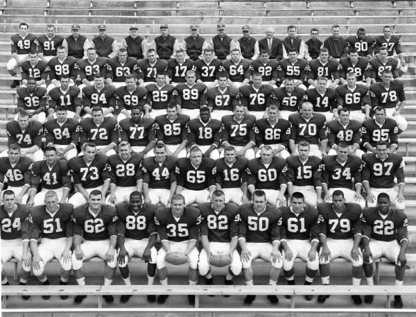 1958 Wisconsin Badgers football team seated on bleachers for a team portrait.