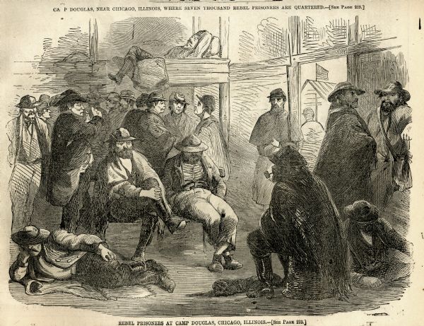 Group of Confederate prisoners of war assembled in prison barracks.