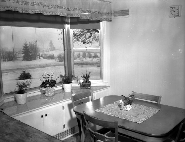 The kitchen in the Westye F. Bakke home at 4818 Odana Road (now 4817 Sherwood Road) showing the breakfast nook of the spacious kitchen which features a large bay window with a blue tile shelf for Mrs. (Mary) Bakke's collection of plants.