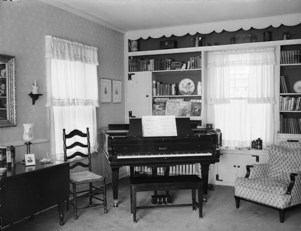 Interior of the Winfield Martin house, 2906 Lakeland Avenue (earlier address, 611 Elmside Boulevard), showing a corner of the living room with a piano. Built as a carriage house for James and Minnie Corry, in 1911, remodeled as a residence in 1946.