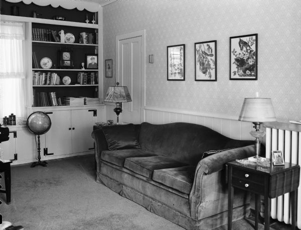 The living room of the Winfield Martin house, 2906 Lakeland Avenue (earlier address, 611 Elmside Boulevard), with built-in bookcases, cupboards ande a free standing globe. Built as a carriage house for James and Minnie Corry, in 1911, it was converted into a residence in 1946.