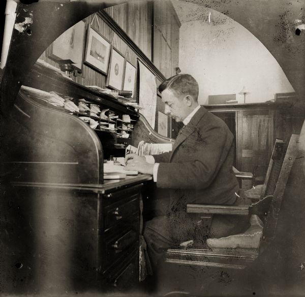 Reuben Gold Thwaites seated at his desk in his office at the Wisconsin Historical Society.