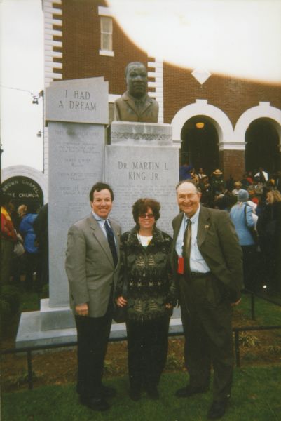 Congressman Michael Forbes, an unidentified woman, and Robert Zellner pose in front of the Martin Luther King, Jr. monument in front of the Brown Chapel Baptist Church.