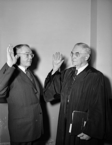 Former attorney general Grover Broadfoot being sworn in as the newest member of the Wisconsin Supreme Court by Chief Justice Marvin B. Rosenberry. He was appointed by Governor Rennebohm to succeed Justice Elmer E. Barlow who died the past June.