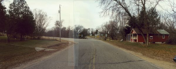 Panoramic view of Waupaca County Highway K as it curves near a house.
