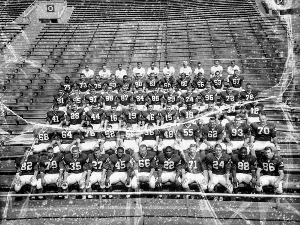 1957 University of Wisconsin Badgers football team seated on bleachers for team portrait.