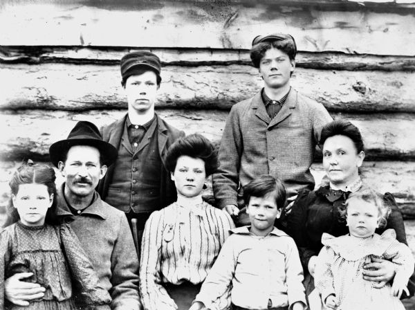 Casual family portrait of John Deitz and his wife and five children.