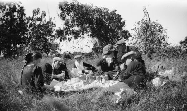 Members of the Brandel family have a picnic in the grass.