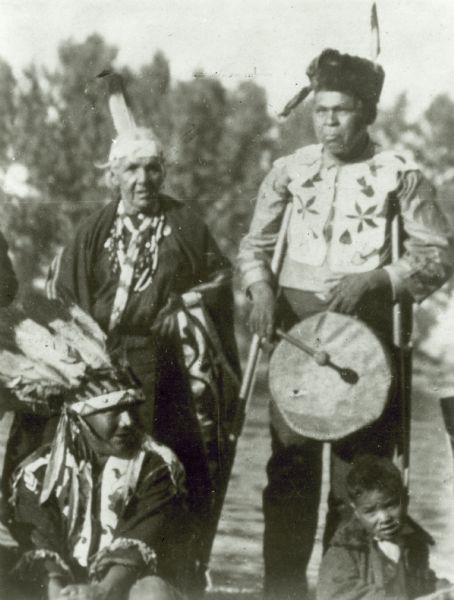 Menominee Indians of the Zoar Settlement in Northern Wisconsin performing a dream dance. Standing figures: "Grandma" Dutchman and husband "Charlie."