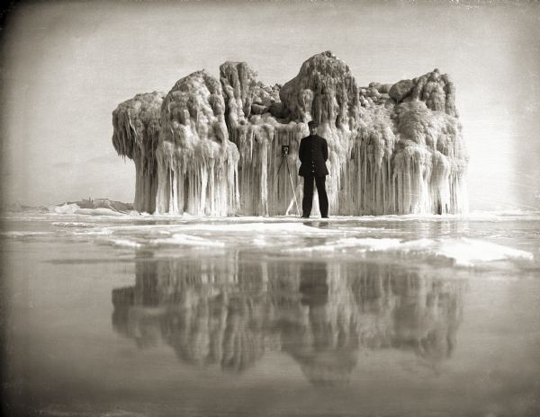 George Malone and his camera in front of an ice formation on the Milwaukee (Bayview) shoreline of Lake Michigan.