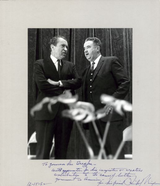 Richard Nixon and Governor Lee Sherman Dreyfus standing together having a discussion. Inscribed on bottom of print, "To Sherman Lee Dreyfus — With appreciation for his imagination and creative contribution to the cause of bettering government in America — from his friend, Richard Nixon.