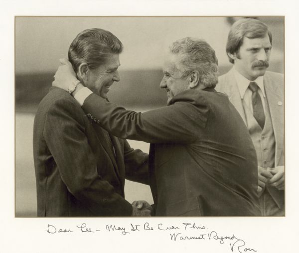 Lee Sherman Dreyfus and Ronald Reagan embracing and clasping hands in greeting.