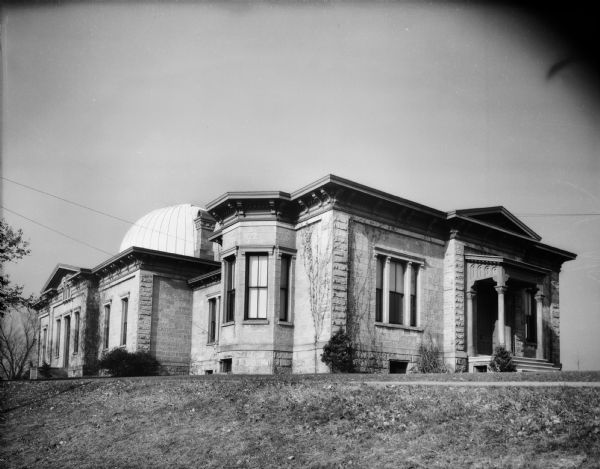 Exterior view of the Washburn Observatory at the University of Wisconsin-Madison. There is a small, covered entrance on the right side of the building.