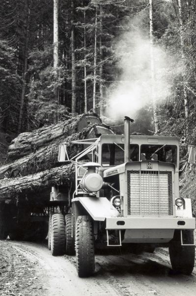Driver Roman (Bud) J. Engels driving an International 8066 Heavy Equipment Transporter (HET) used for logging.