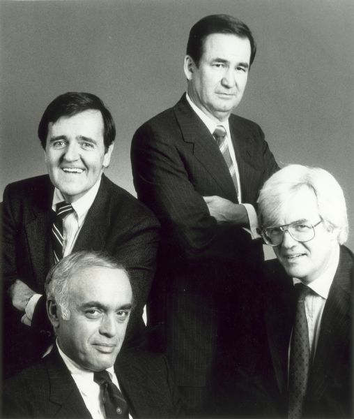 Publicity portrait of the four original stars of the CNN news program <i>Capital Gang</i>: (clockwise from the lower left) Robert Novak, Mark Shields, Pat Buchanan, and Al Hunt. <i>Capital Gang</i> began in 1988 and the four continued until Buchanan left to run for President. The program continued until 2005.