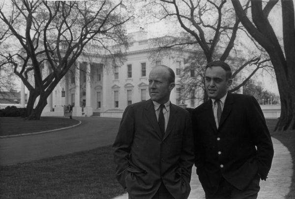Publicity portrait of journalists Rowland Evans and Robert Novak taken outside the White House. Their long-running newspaper column was entitled <i>Inside Report</i>.