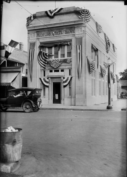 Exterior view from across street of the People's State Bank decorated to honor the 250th anniversary of the discovery of the Mississippi River.