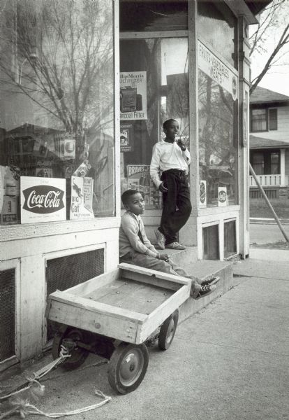 The corner grocery is a pleasant place for the pause that refreshes. Thaddeus Moore, 9, of 3271 N. 14th Street, had a cone. Anthony McMillon, 7, of 3287-A N. 14th Street, enjoyed the comfort of the steps.