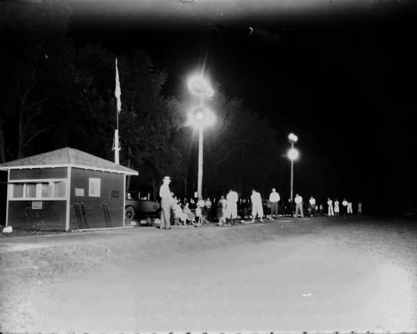 Golfers teeing off at at night at the Morgan Driving Course, Mineral Point Road opposite Holly Avenue, Westmorland.