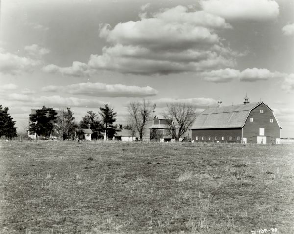 The William Langenbaw farm, viewed against a cloud-filled sky.