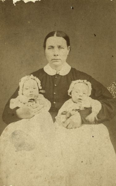 Studio portrait of Mrs. Iver Eken and her twin babies.
