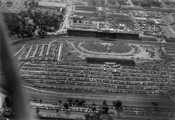 Aerial view of the Wisconsin State Fairgrounds, including the grandstands, racetrack, and parking lot.