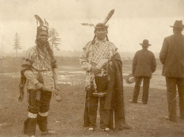 Chief Cloud, in center, of the Chippewa Indians (Ojibwa) standing outdoors with other men.