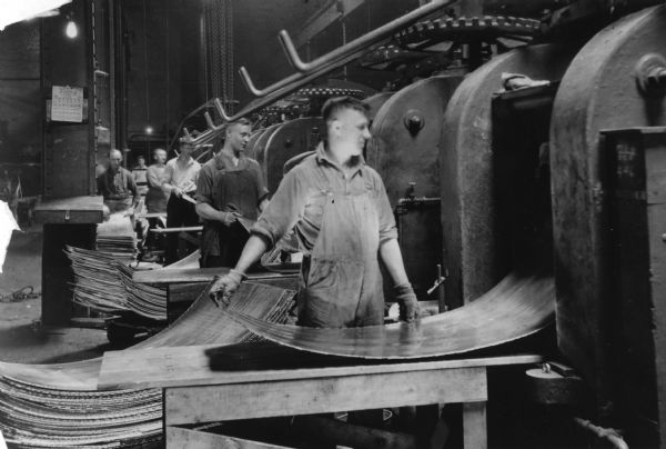 Men rolling aluminum by hand at the Mirro Aluminum Company.