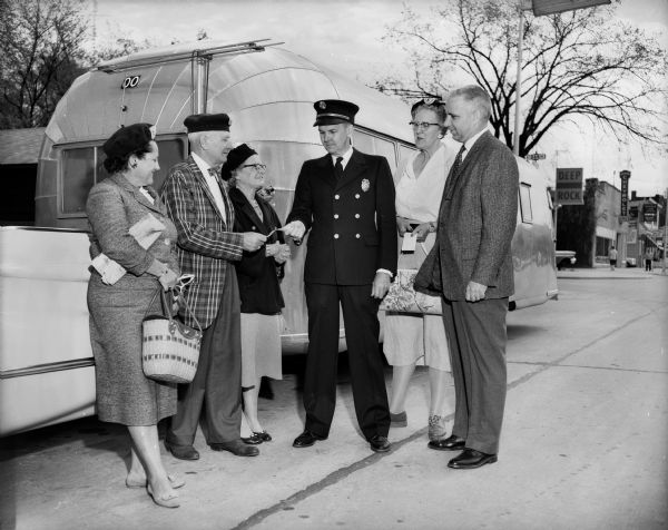 Trailer Convention Officials, including the Mayor and the Police Chief, standing outside near an Airstreamer.