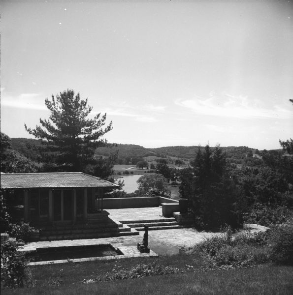 Elevated exterior view of Taliesin looking towards Frank Lloyd Wright's bedroom and the terrace off his bedroom as seen from the garden.  Taliesin was the summer home of Frank Lloyd Wright. In the background is the Wisconsin River, and hills beyond. Taliesin is located in the vicinity of Spring Green, Wisconsin.