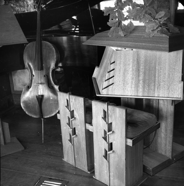 Music stand, chairs, piano, and cello or string bass in the living room of Taliesin, the summer home of Frank Lloyd Wright.  Taliesin is located in the vicinity of Spring Green, Wisconsin.