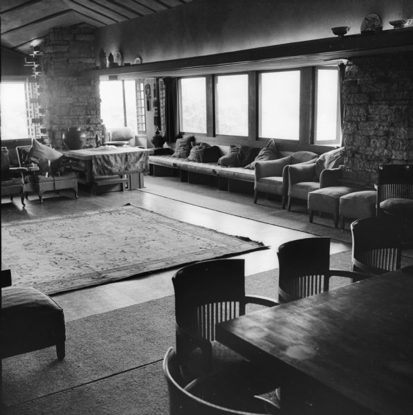 Living room of Taliesin, the summer home of Frank Lloyd Wright, looking west. A portion of the dining room table can be seen in the right foreground. Taliesin is located in the vicinity of Spring Green, Wisconsin.