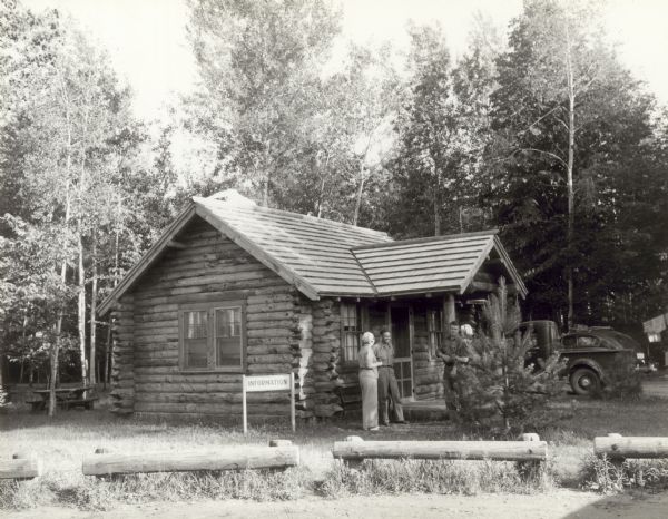 Four people outside of the information cabin at Copper Falls State Park.