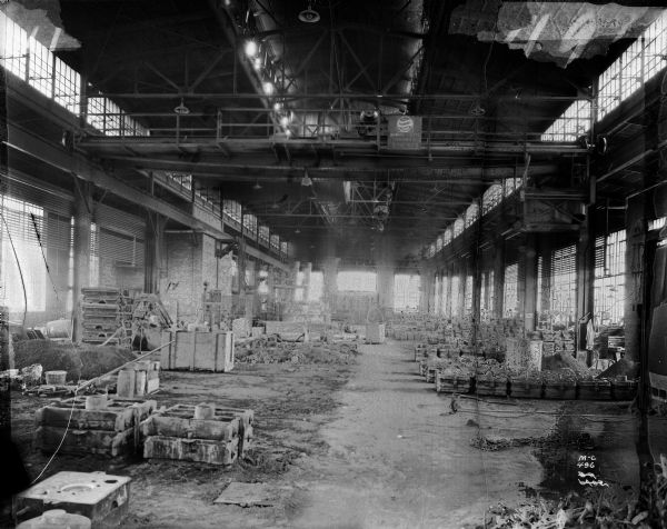A Milwaukee Electric Crane and Manufacturing Company 5 ton crane, No. 137, in a foundry.