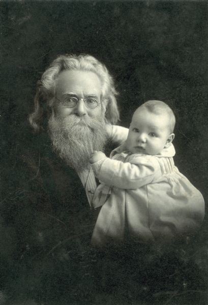 Studio portrait of Moses Harman, 75-years-old, holding his baby grandson George Harman O'Brien, 4-months-old.