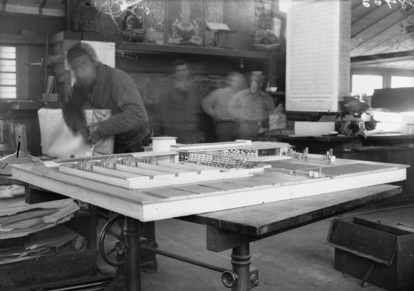 Model of a Unified Farm building designed by architect Frank Lloyd Wright on a table at Taliesin, Wright's home in Wisconsin.<p>The date for this image is the year indicated on the BAVI copy negative jacket, several years before the establishment of the Taliesin Fellowship. Taliesin is located in the vicinity of Spring Green, Wisconsin.</p>