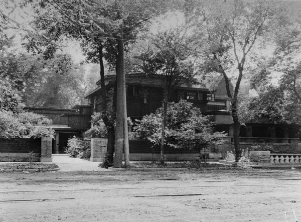 Exterior of the residence of architect Frank Lloyd Wright. The studio wing is shown after its transformation into an apartment for Wright's first wife and the children that remained in her care. The octagonal second story has been altered into a square, but the octagonal roof structure is intact.