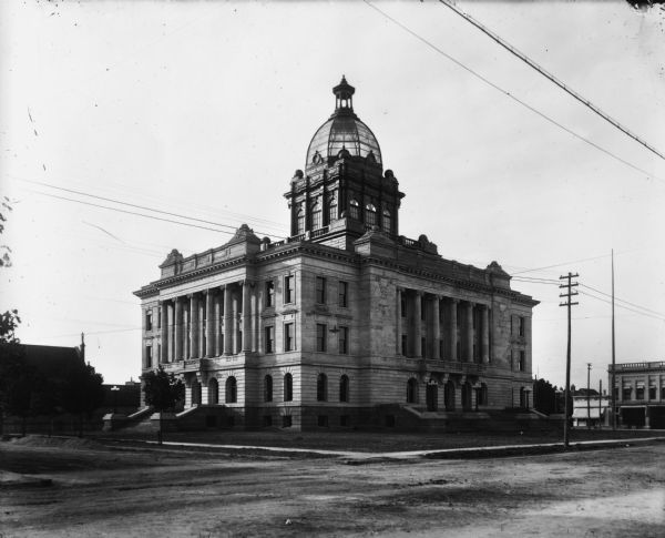 Exterior view of the Manitowoc County Courthouse featuring a glass dome.