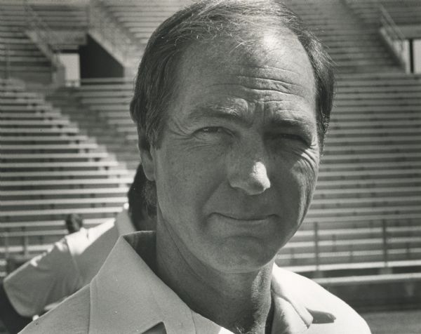 Informal portrait of Green Bay Packers head coach, Bart Starr, probably taken at Lambeau Field. Empty bleachers are visible in the background.