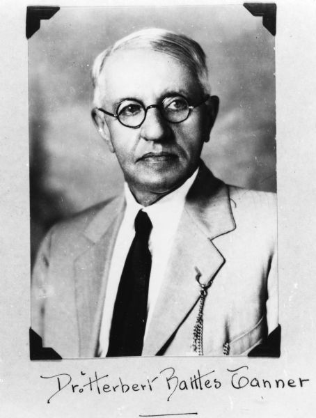 Quarter-length portrait of Dr. Herbert Battles Tanner wearing a tie and eyeglasses.