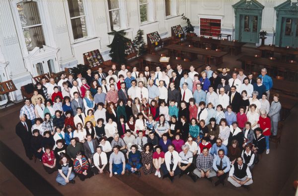 Color portrait from balcony of the Historical Society staff taken in the Library to illustrate the cover of a special issue of the <i>Magazine of Wisconsin History</i> that marked the Society's 100th anniversary. An identification sheet is filed with the print.