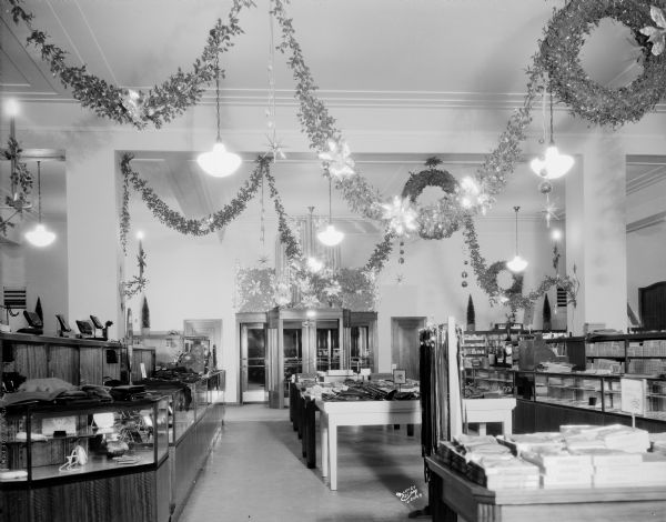 First floor of Manchester's Department Store showing Christmas decorations. An entrance is along the back wall.