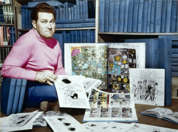 August Derleth posed with part of his comic collection. The image is from a tinted photograph by Carmie Thompson.